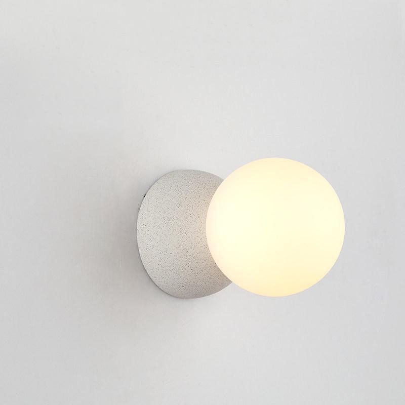 Eirinise wandlamp van beton en melkglas