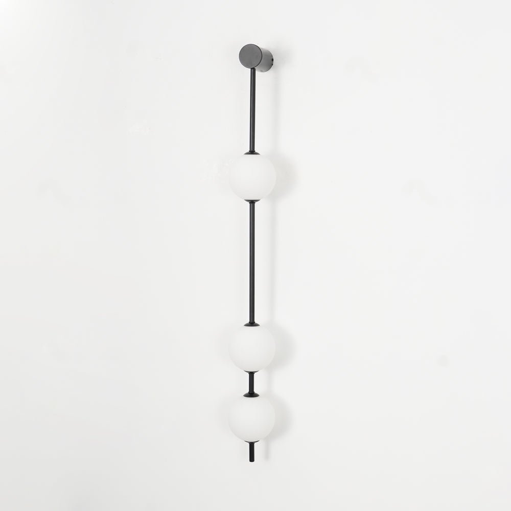 Soloiella wandlamp met verticale bollen van messing