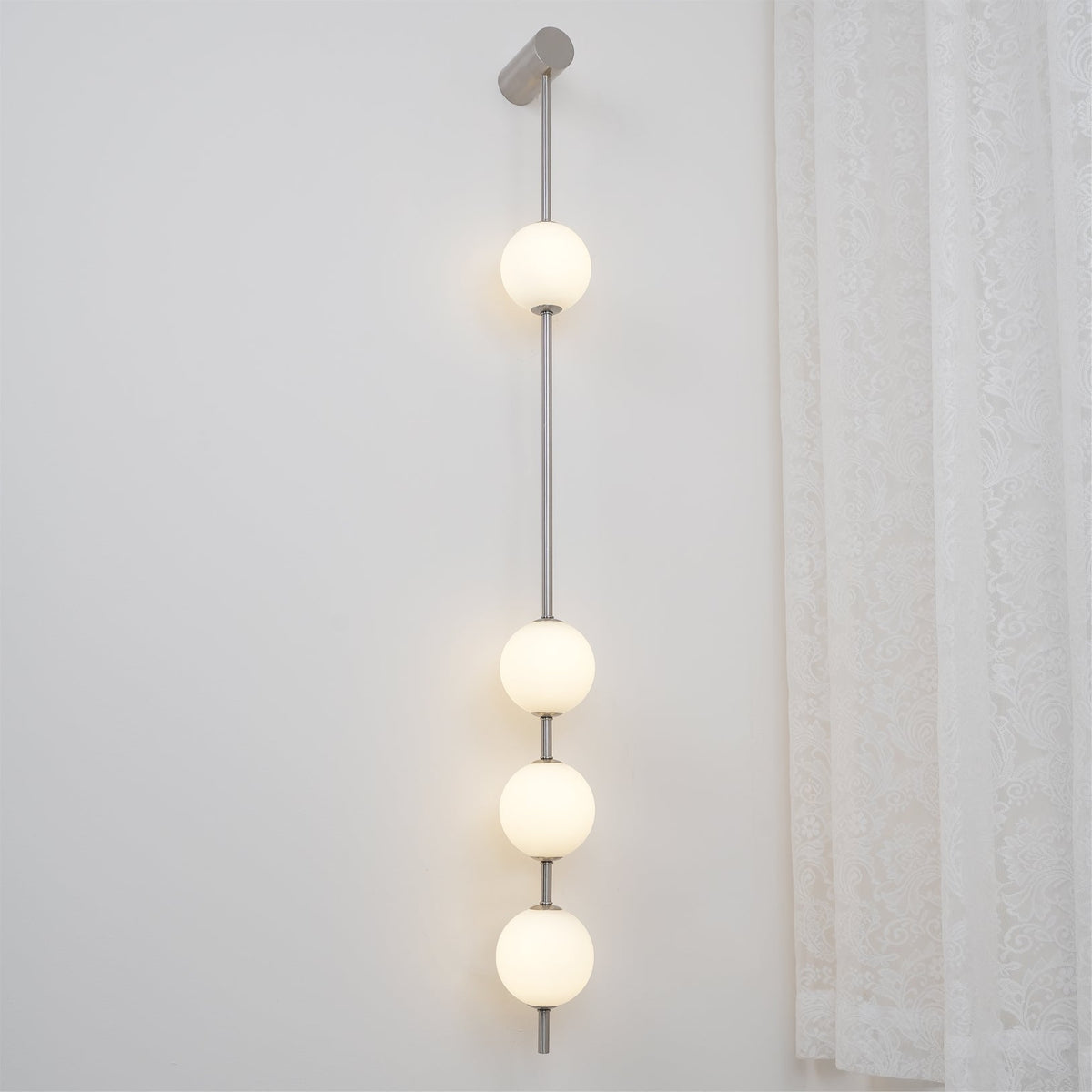Soloiella wandlamp met verticale bollen van messing