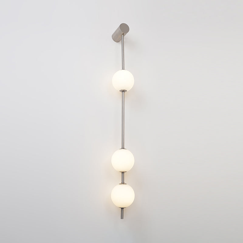 Soloiella wandlamp met verticale bollen van messing