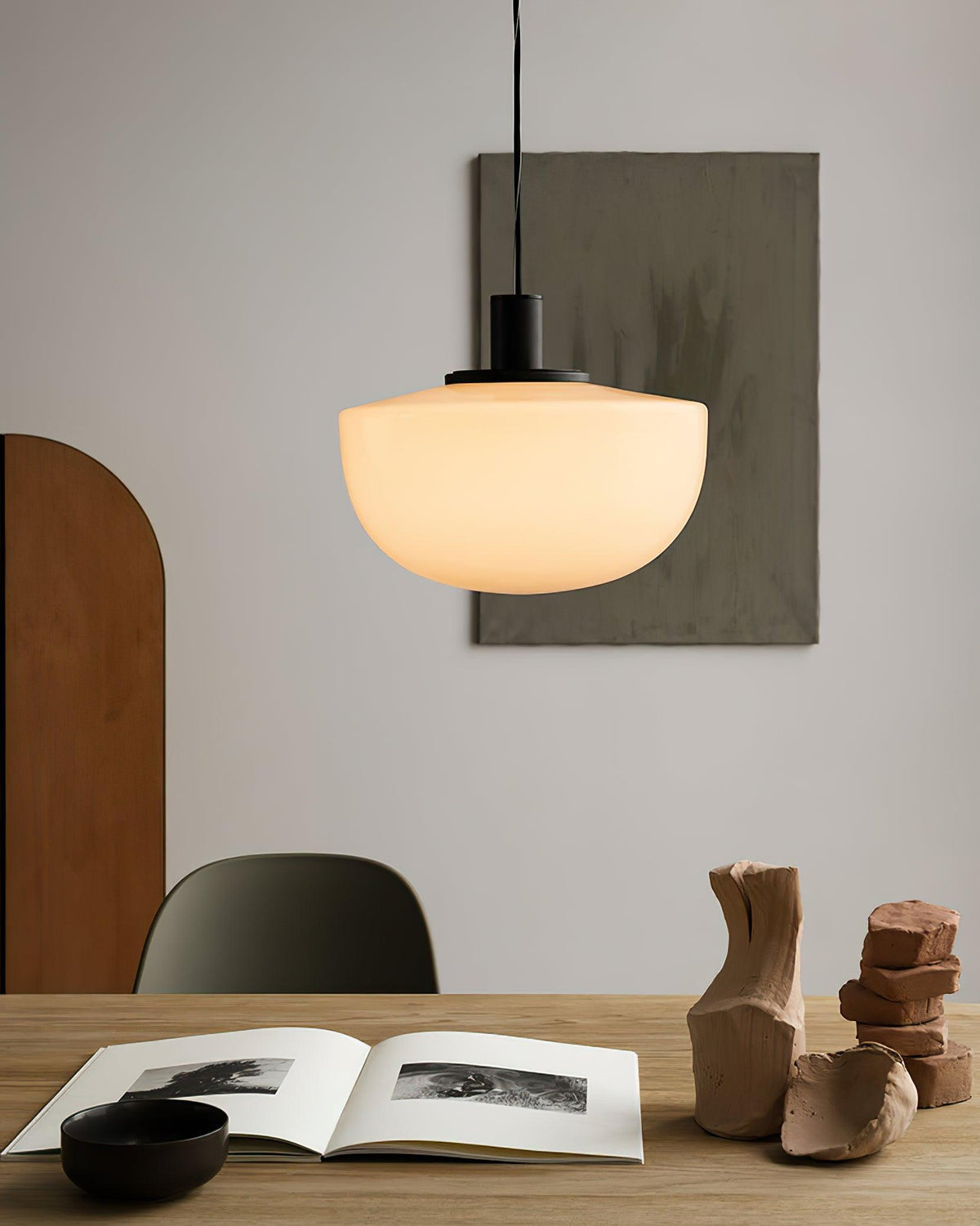 Moderne hanglamp met glazen koepel en metalen bevestiging in minimalistisch ontwerp