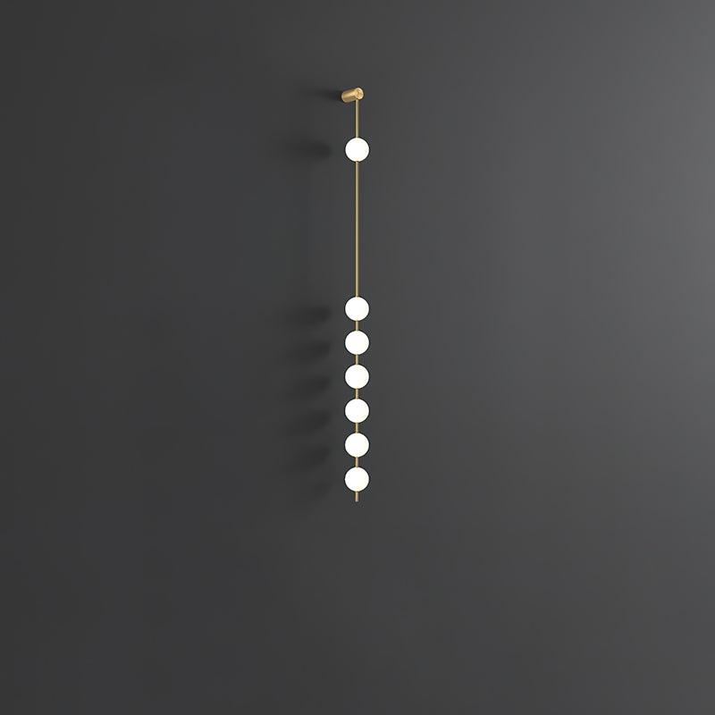 Soloiella wandlamp met verticale bollen van messing